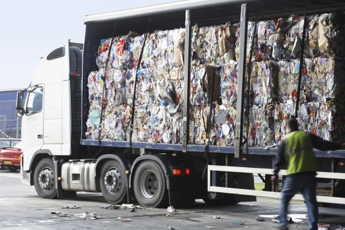 Commercial waste crew loading a skip with protective equipment